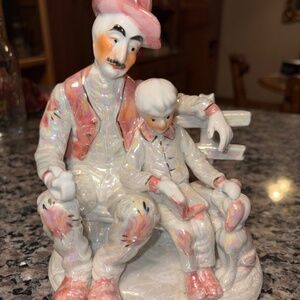 Staffordshire Man and boy on a bench reading